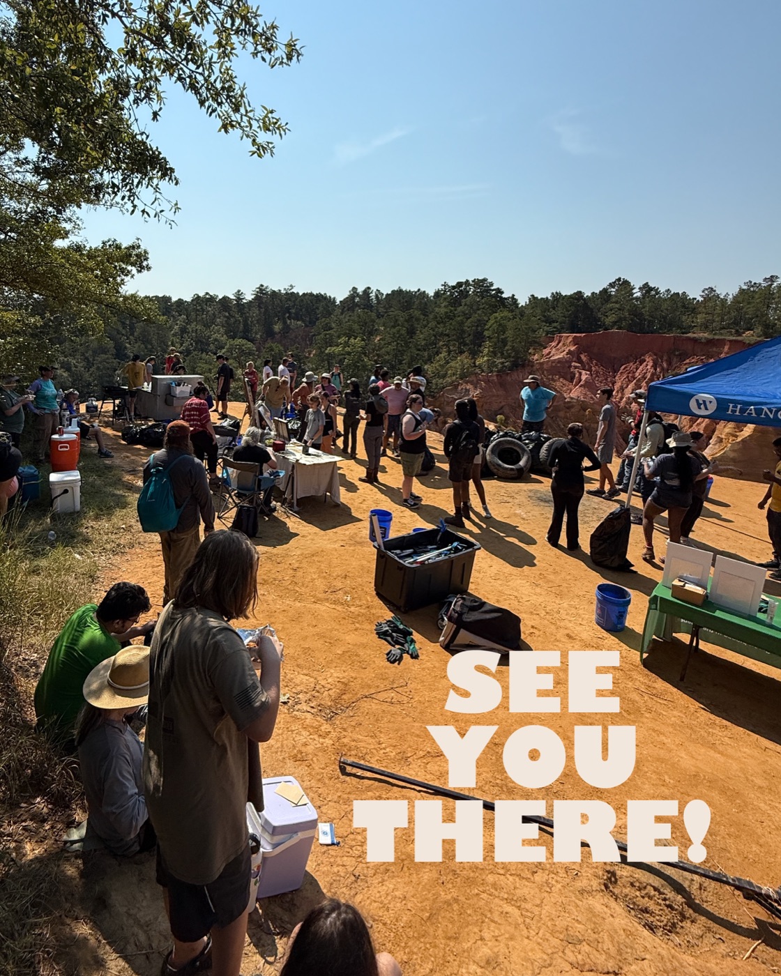 Volunteers gathered at the top of Red Bluff at last year's cleanup, with the red clay canyon behind them